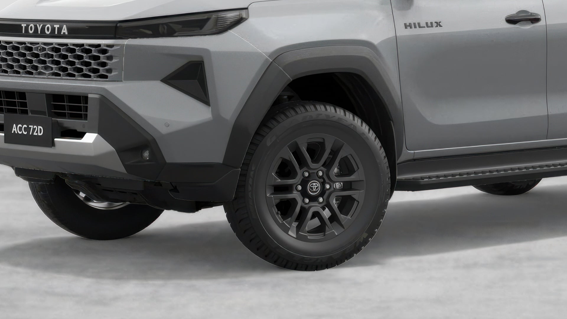 A HiLux double-cab ute with Alloy Wheels. The wheels are painted black, with 6-spokes and a Toyota logo on the hubcap.