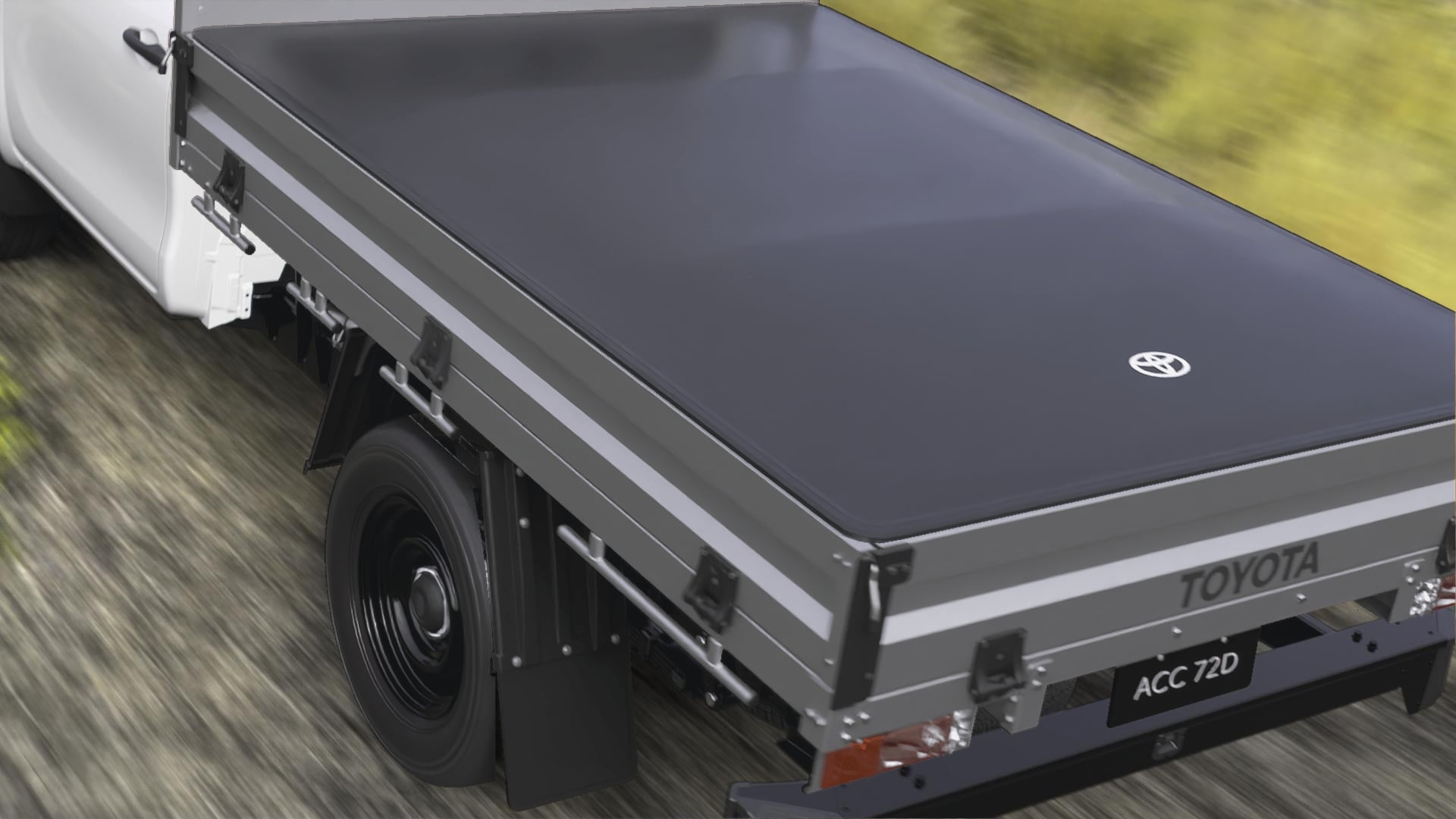 A rear view of a Glacier White HiLux ute with a steel tray. The tray has a black, Soft Tonneau Cover stretched neatly over it, with a small white Toyota logo near the tailgate.
