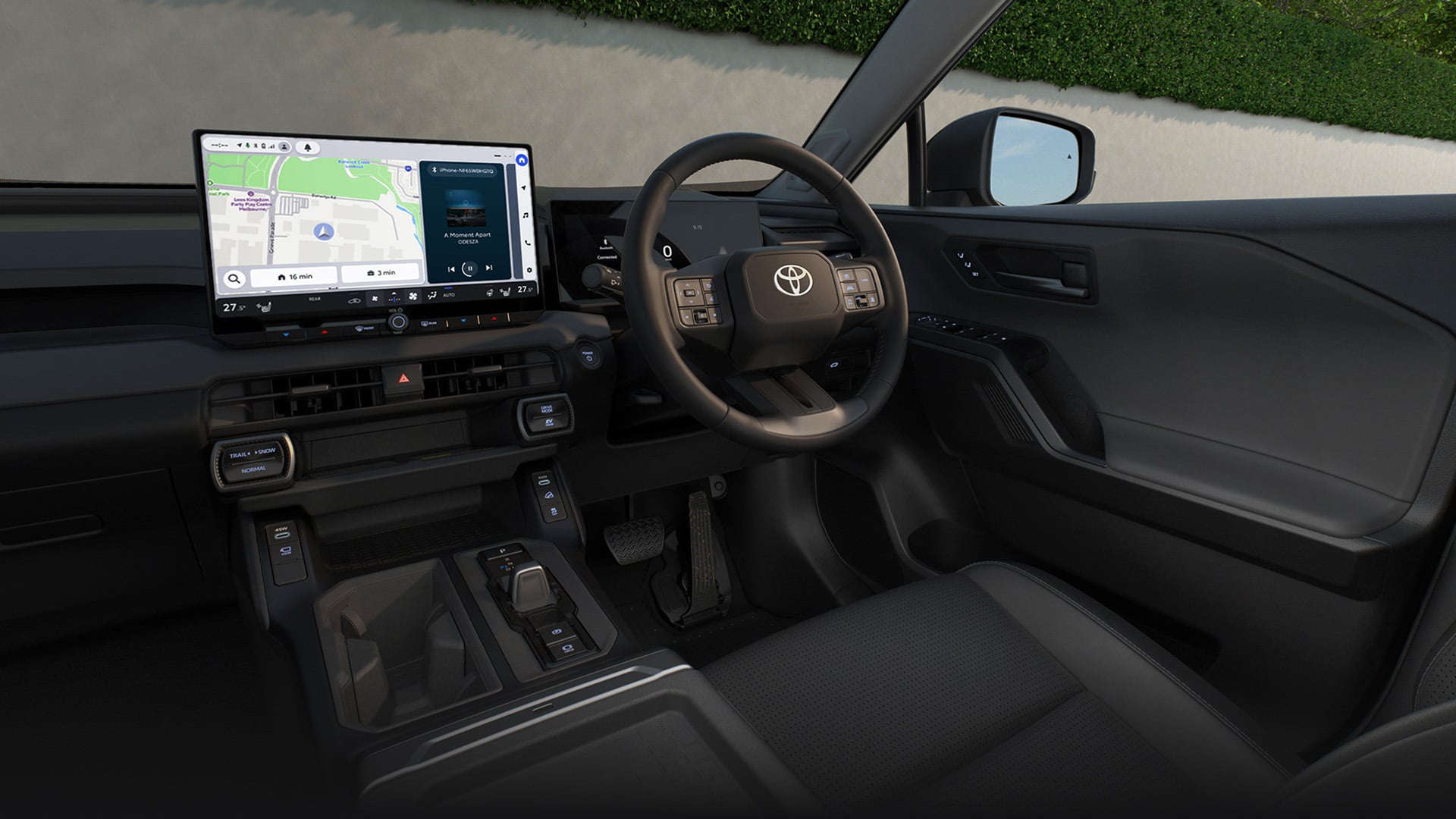 The dark-panelled interior cockpit of the RAV4, with all its driving features including a large multimedia screen with app icons.