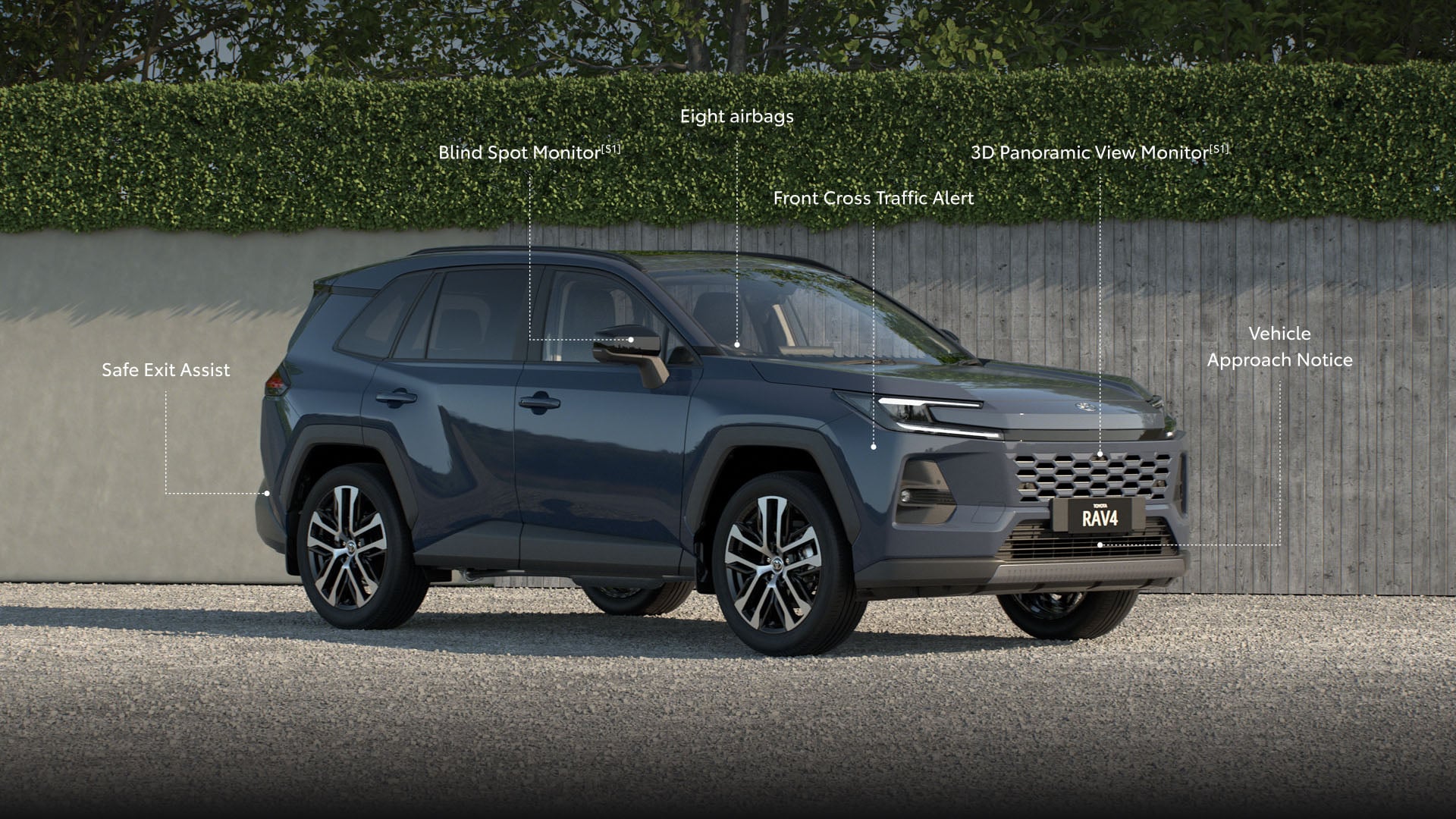 The RAV4 in Massive Grey sits on a suburban driveway with a grey fence and hedges behind it. Annotated in white text are its safety features including Safe Exit Assist, 8 airbags, Blind Spot Monitor with Rear Vehicle Approach Indicator, 3D Panoramic View Monitor, Front Cross Traffic Alrt and Vehicle Approach Notice.
